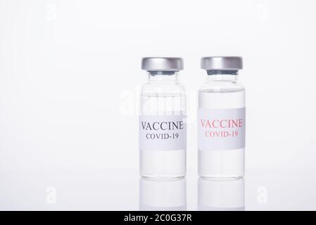 Immunization and COVID-19 treatment concept. Close-up photo of two COVID-19 vaccine vials isolated on white background Stock Photo