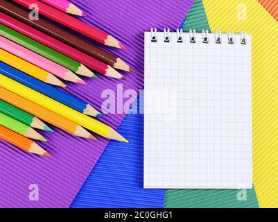Color pencils on  paper with notebook Stock Photo