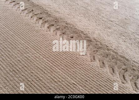 Tire tracks in the sand Stock Photo