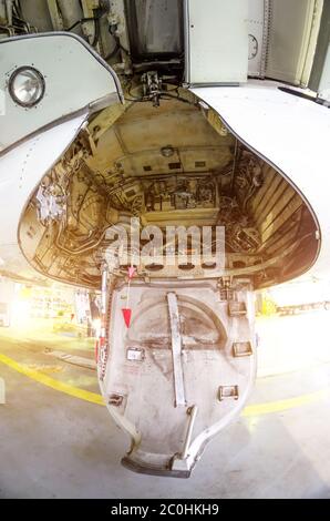 Large passenger airplane maintenance personnel working on aircraft main landing gear repair detail exterior close up view Stock Photo