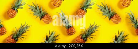 Seamless horizontal texture, pineapples on a yellow background. Stock Photo