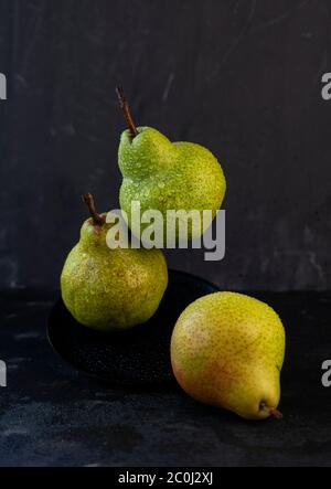 selective focus: large ripe pears with water drops on a dark background Stock Photo