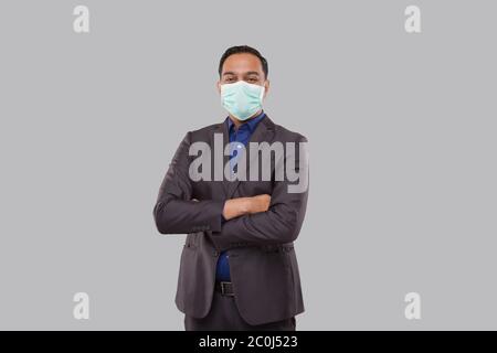 Businessman Hands Crossed Wearing Medical Mask Isolated. Indian Businessman Standing Stock Photo