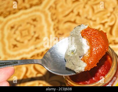 Mold growing on the tomato paste. Close up Stock Photo