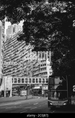 Double decker bus waiting on a bus stop in residential part of Hong Kong Stock Photo