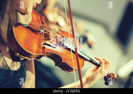 Symphony orchestra on stage, hands playing violin Stock Photo