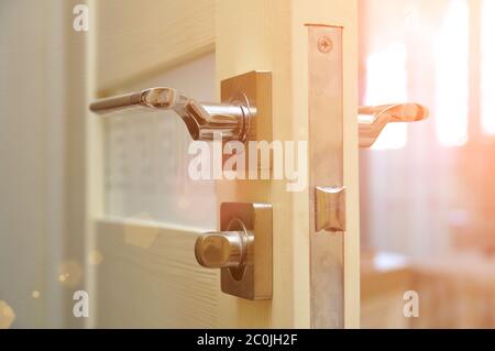 Modern style doorknob on a wooden door. Door lock Stock Photo