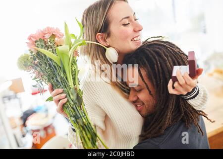 Men give women jewelry and flowers for Valentine's Day or propose marriage with a wedding ring Stock Photo