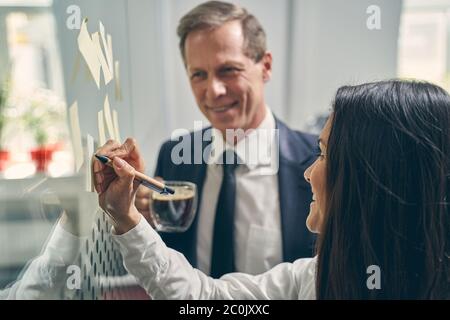 Charming young woman demonstrating her business plan Stock Photo