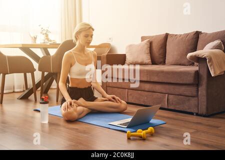 Sporty woman working out on a mat Stock Photo