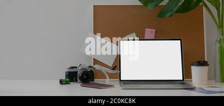 Overhead shot of female artist working with mock-up tablet, painting tools and drinking coffee on office desk Stock Photo