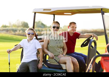 Family portrait in a cart at the golf course Stock Photo