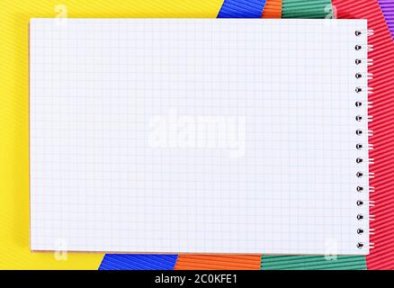 Writing-book in cage on color paper Stock Photo