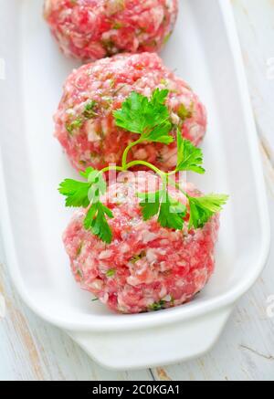 Raw meat balls in the white bowl Stock Photo