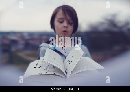 Smiling woman in yellow top holding a book. Side pose Stock Photo | Adobe  Stock