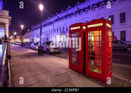 London, Grossbritannien. 03rd Mar, 2012. 03.03.2012, an atmospheric night shot with two typical, English, red K6 telephone booths (designer: Sir Giles Gilbert Scott) and a few parked cars in Lancaster Gate. | usage worldwide Credit: dpa/Alamy Live News Stock Photo