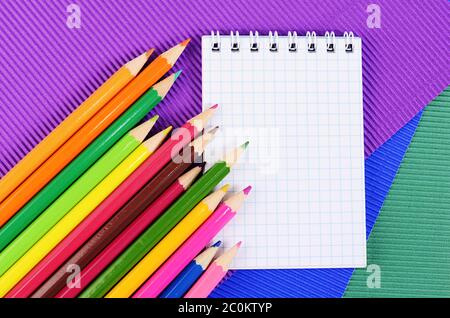 Color pencils on  paper with notebook Stock Photo
