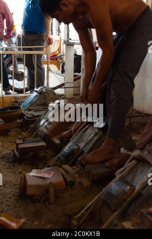 Young craftsman punching gold with a hammer Stock Photo