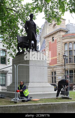 Barriers are erected around the statue of former US President Abraham Lincoln in Parliament Square, London, following a raft of Black Lives Matter protests took place across the UK over the weekend. The protests were sparked by the death of George Floyd, who was killed on May 25 while in police custody in the US city of Minneapolis. Stock Photo