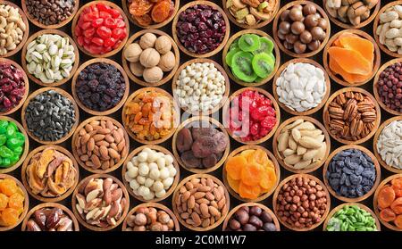 mixed nuts and dried fruits in bowls, top view. healthy snack for vegetarian, food background. Stock Photo