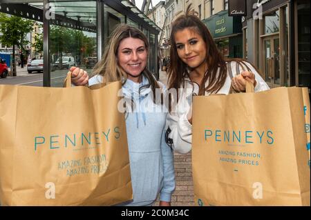 Cork, Ireland. 12th June, 2020. Penneys Clothes Stores around the country with street access reopened this morning. Pictured with their purchases of jeans and tops are Sophie Howard from Ballyvolane and Kinga Nalewa from Douglas. Credit: AG News/Alamy Live News Stock Photo