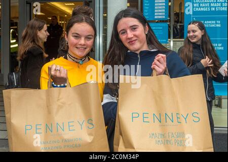 Cork, Ireland. 12th June, 2020. Penneys Clothes Stores around the country with street access reopened this morning. Pictured with their purchases of towels and shorts are Erin Goulding and Zoe Doyle from Douglas. Credit: AG News/Alamy Live News Stock Photo