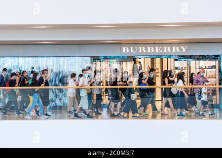 Protesters march through a Burberry store in a shopping mall in Central district during the demonstration.Pro democracy demonstrators hosted a demonstration in the Pacific Place shopping mall in the C...