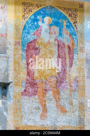 Fresco of St. Christopher on an exterior wall of the Romanesque-Gothic church of St. John the Baptist which was built circa 1100 on the shores of Lake Stock Photo