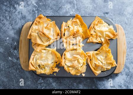 healthy plant-based food recipes concept, filo pastries in muffin tray with veggies filling Stock Photo