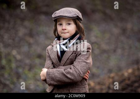 Adorable boy on a railway station, waiting for the train, running and playing Stock Photo