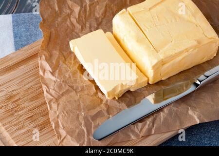 Wooden board with butter on blue checkered napkin Stock Photo