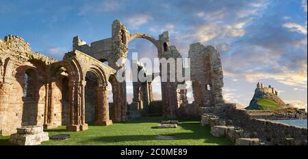 The Anglo Saxon Romanesque Lindisfarne Abbey ruins looking to Lidisfarne Castle,  Holy Island, Lindisfarne, Northumbria, England
