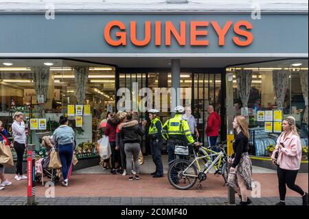 Cork, Ireland. 12th June, 2020. Gardai were called to Michael Guineys store in Oliver Plunkett Street, Cork city this morning to help control the crowds of people queuing. Credit: AG News/Alamy Live News Stock Photo