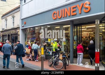 Cork, Ireland. 12th June, 2020. Gardai were called to Michael Guineys store in Oliver Plunkett Street, Cork city this morning to help control the crowds of people queuing. Credit: AG News/Alamy Live News Stock Photo