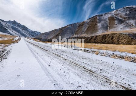 the gravel road on the snow mountain Stock Photo