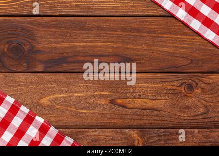 checkered tablecloth on wooden table. creative photo. Stock Photo