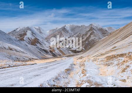 the gravel road on the snow mountain Stock Photo