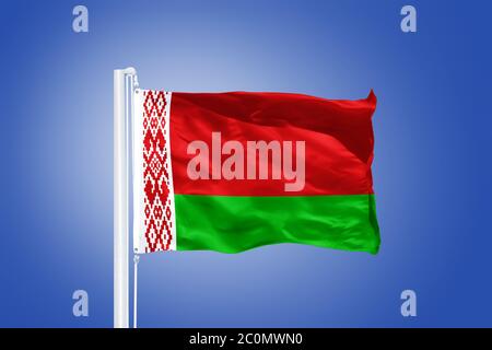 Flag of Belarus flying against a blue sky Stock Photo