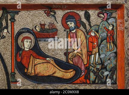 Nativity scene (L) and the Annunciation of the Shepherds (R) depicted in the Romanesque antependium (altar frontal), known as the Antependium from Cardet dated from the second half of the 13th century originally from the church of Santa Maria de Cardet in the area of Vall de Boí in Alta Ribagorça in Catalonia, Spain, now on display in the National Art Museum of Catalonia (Museu Nacional d'Art de Catalunya) in Barcelona, Catalonia, Spain.