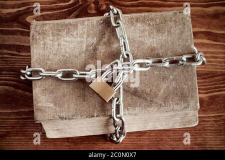 Old book with chain and padlock Stock Photo