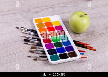 Watercolor paints on wooden background Stock Photo