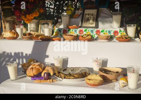 Merida, Mexico - 31 October 2018: Traditional altar for day of the dead, dia de los muertos with food offerings and photos of deceased Stock Photo