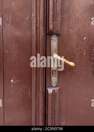 Door handle. Brown wooden door. Stock Photo