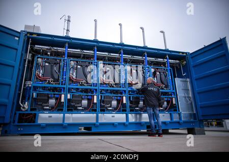 Laage, Germany. 12th June, 2020. Plant manager Guido König from the company Apex Energy is testing the fuel cell in what the company says is the largest grid-connected hydrogen power plant in Europe. From autumn 2020, Apex will supply green energy for industry and commerce, housing companies, public transport or for the intermediate storage of control energy. Up to 300 tons of hydrogen can be produced annually from exclusively renewable energy sources. Credit: Jens Büttner/dpa-Zentralbild/dpa/Alamy Live News Stock Photo