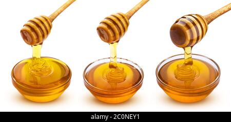 Honey stick and bowl of pouring honey isolated on white background Stock Photo
