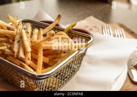 Freshly maid thin french fries on white paper tissues Stock Photo