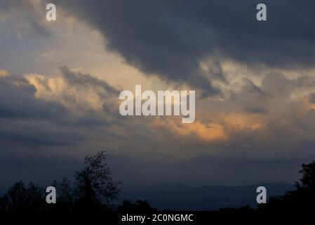 a summer thunderstorm in the Blue Ridge Mountains of Virginia depicting dramatic cloud color, a rain storm, green mountains and trees.  Weather. Stock Photo