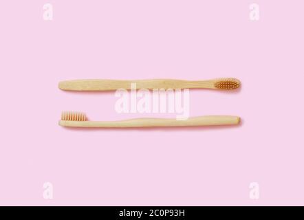 Top view of organic zero waste bamboo toothbrushes on pink background Stock Photo