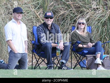 Reese Witherspoon, husband Jim Toth and ex husband Ryan Phillippe watch their son Deacon Phillippe play soccer in Brentwood, California. November 2012 Stock Photo