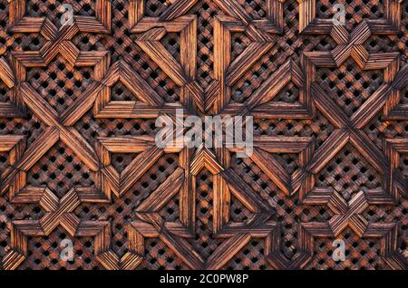 Fez, Morocco. Detail of a beautiful original medieval wall panel in the city's historical Medina. Decorated in Arabesque, Islamic symmetrical design. Stock Photo